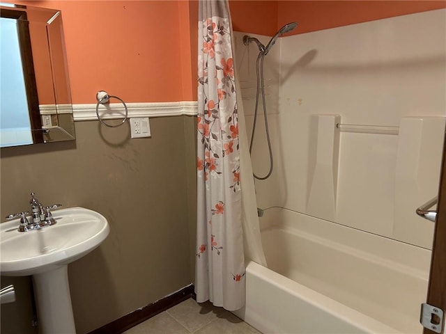 bathroom featuring shower / bath combination with curtain, sink, and tile patterned flooring