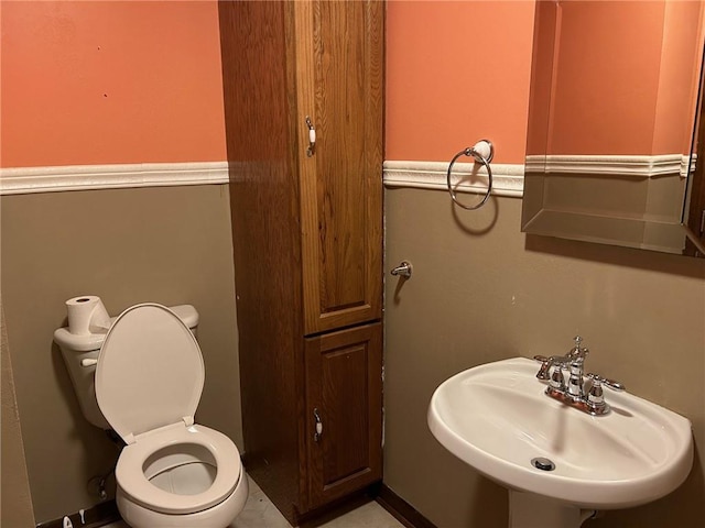 bathroom featuring sink and toilet