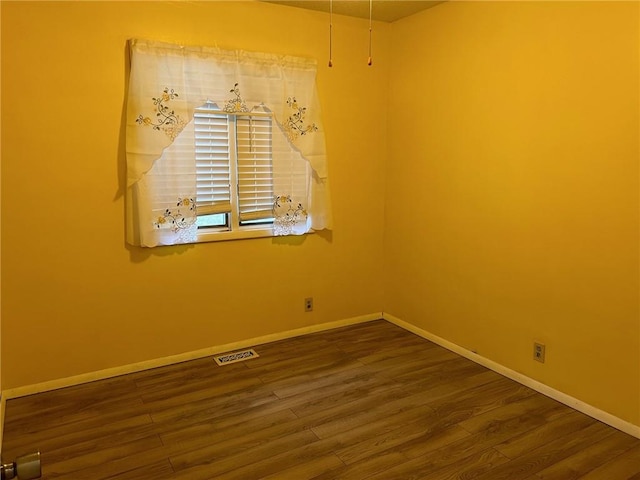 spare room featuring dark hardwood / wood-style flooring