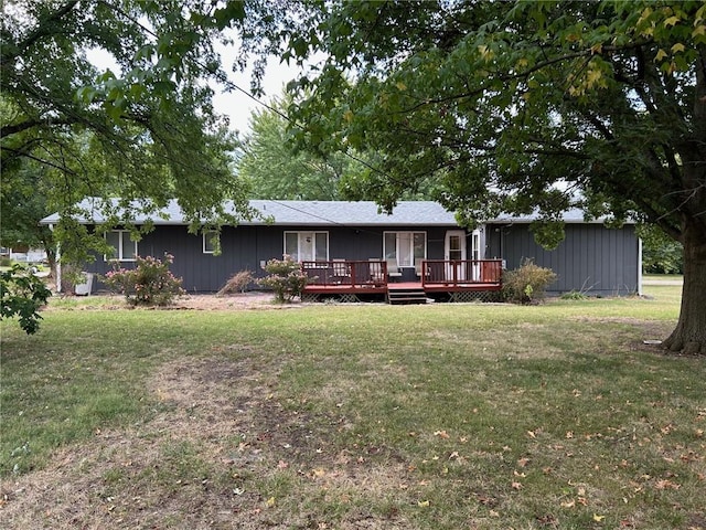 view of front of house with a deck and a front lawn