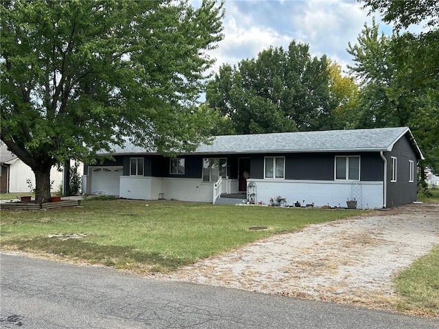 single story home with a garage and a front yard