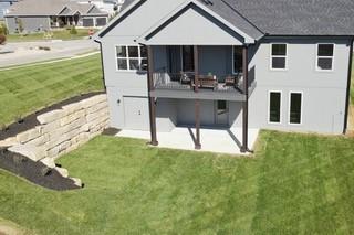 rear view of property featuring a lawn