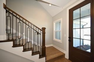 doorway to outside with plenty of natural light, stairs, dark wood-type flooring, and lofted ceiling