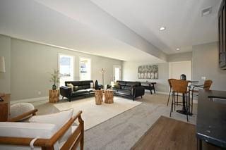 carpeted living room with baseboards