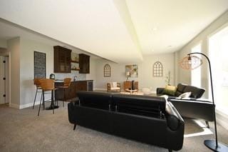 carpeted living area with baseboards