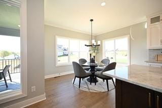 dining space featuring a notable chandelier and dark hardwood / wood-style floors