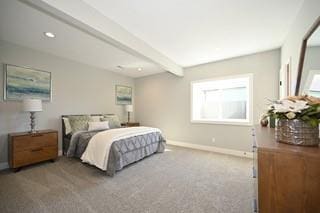 carpeted bedroom with beamed ceiling