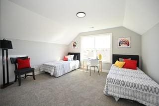 carpeted bedroom with lofted ceiling