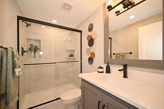 bathroom with vanity, toilet, and a shower with shower door