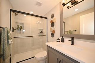 full bathroom with vanity, visible vents, toilet, and a shower stall