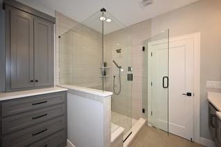 bathroom with vanity and a stall shower