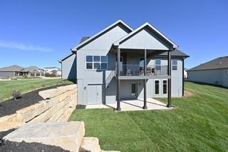 rear view of property with a patio area and a lawn