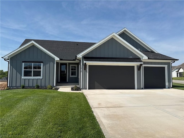 12850 N Arbor Way, Platte City, MO 64079 - view of front of home with board and batten siding, a garage, a front yard, and concrete driveway