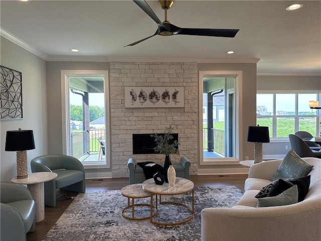 12850 N Arbor Way, Platte City, MO 64079 - living room with wood finished floors, a ceiling fan, ornamental molding, a brick fireplace, and recessed lighting