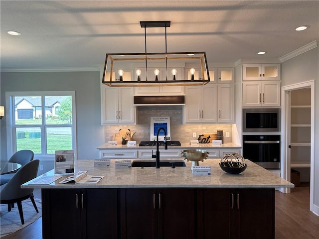 12850 N Arbor Way, Platte City, MO 64079 - kitchen with wall oven, built in microwave, a center island with sink, decorative backsplash, and ornamental molding