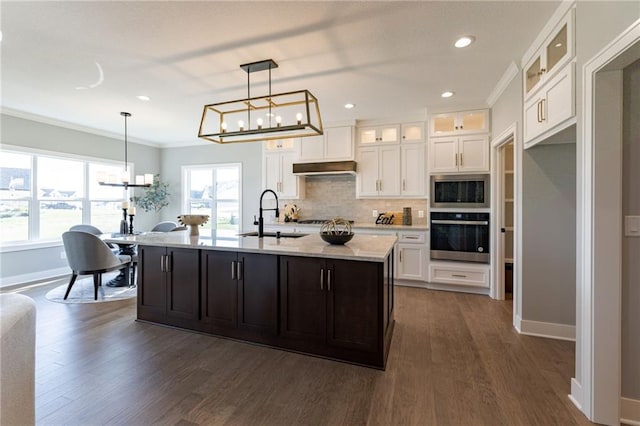 12850 N Arbor Way, Platte City, MO 64079 - kitchen featuring appliances with stainless steel finishes, a chandelier, white cabinets, crown molding, and recessed lighting