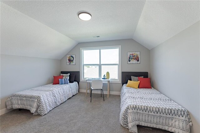 12850 N Arbor Way, Platte City, MO 64079 - carpeted bedroom with vaulted ceiling and a textured ceiling