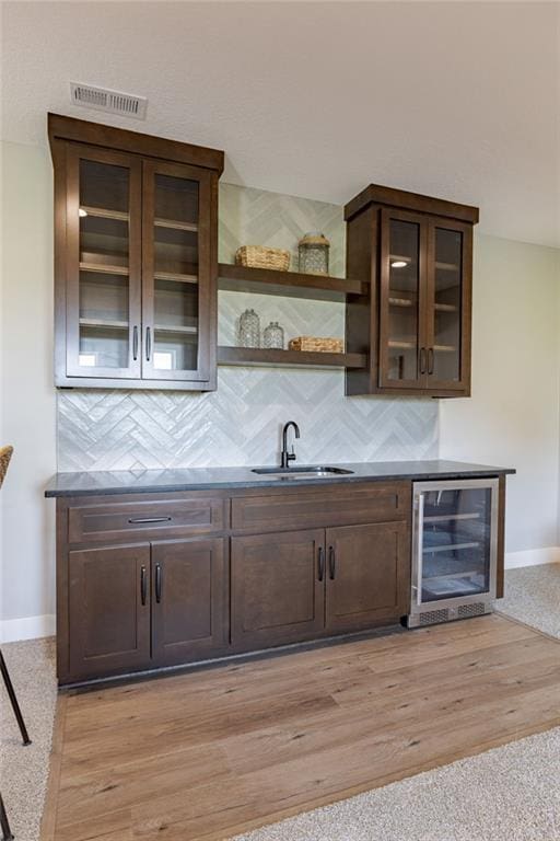 12850 N Arbor Way, Platte City, MO 64079 - indoor wet bar featuring wine cooler and tasteful backsplash
