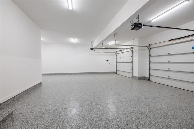 12850 N Arbor Way, Platte City, MO 64079 - garage with a garage door opener and baseboards