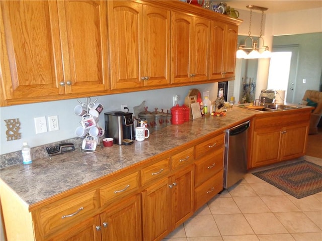 kitchen featuring light tile patterned floors, a sink, brown cabinets, dishwasher, and pendant lighting