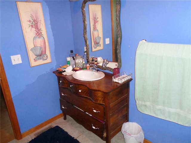 bathroom with tile patterned flooring, baseboards, and vanity