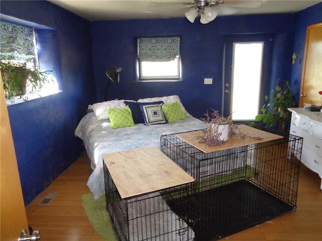 bedroom with visible vents and wood finished floors