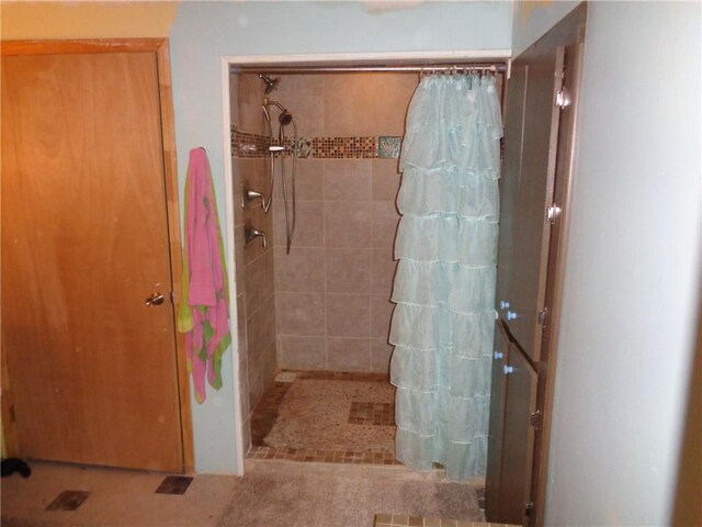 full bath with a tile shower