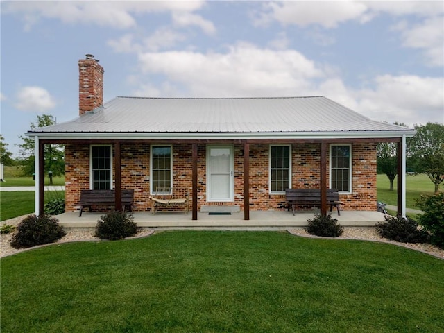 ranch-style home with covered porch and a front yard