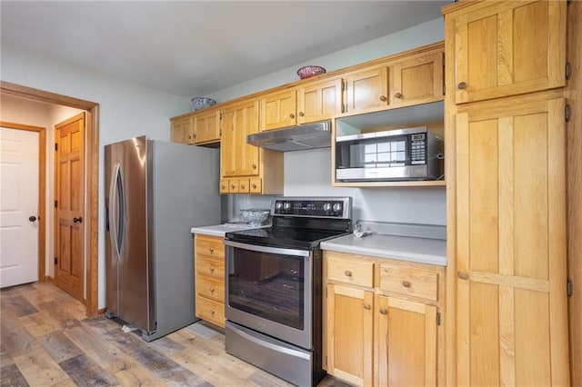 kitchen featuring hardwood / wood-style flooring and appliances with stainless steel finishes