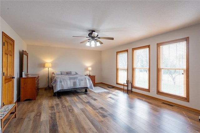 bedroom featuring wood-type flooring and ceiling fan