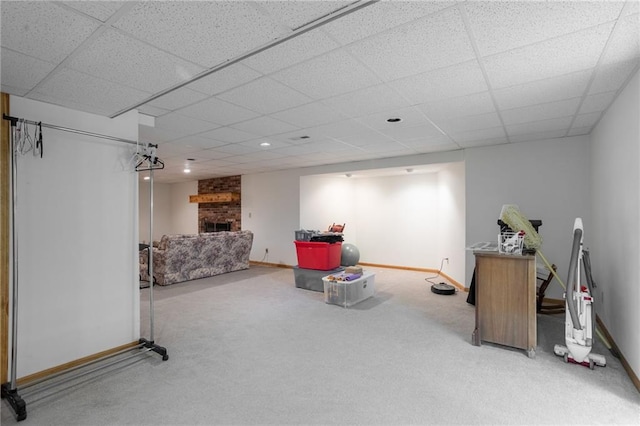 interior space featuring carpet floors, a fireplace, and a paneled ceiling