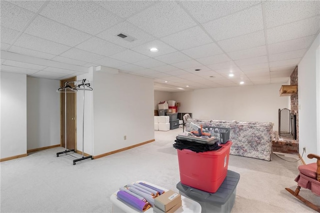 interior space with a drop ceiling and light colored carpet