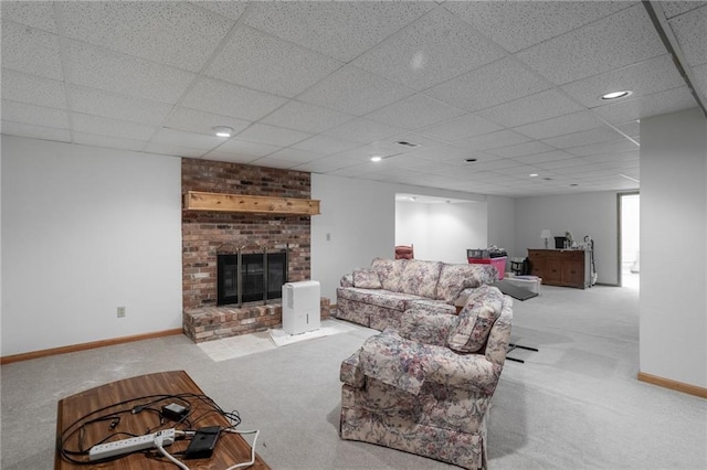 carpeted living room with a brick fireplace and a paneled ceiling