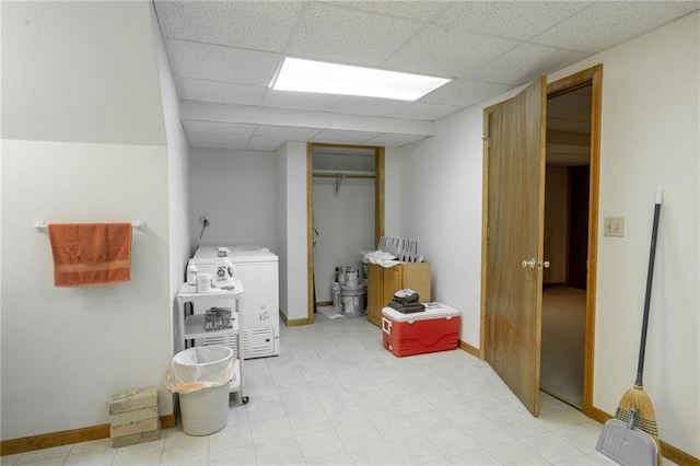 interior space featuring separate washer and dryer and a paneled ceiling