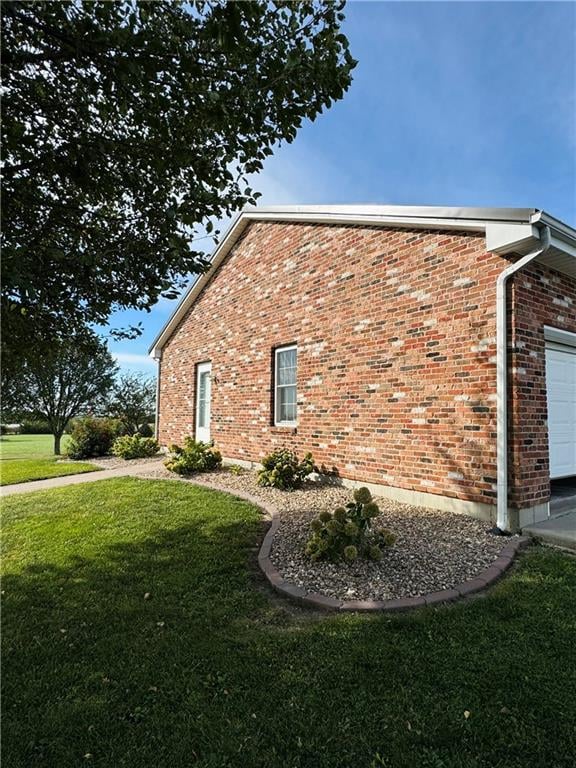 view of home's exterior featuring a lawn and a garage