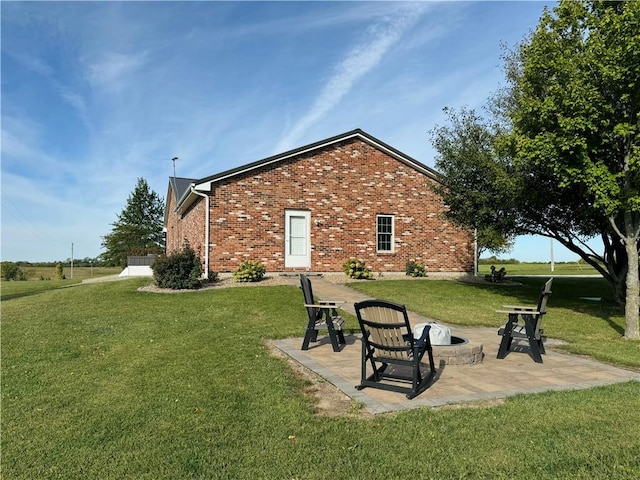 back of property with a yard and a patio