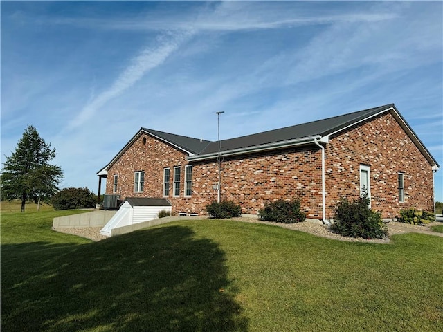 view of home's exterior featuring a lawn and cooling unit