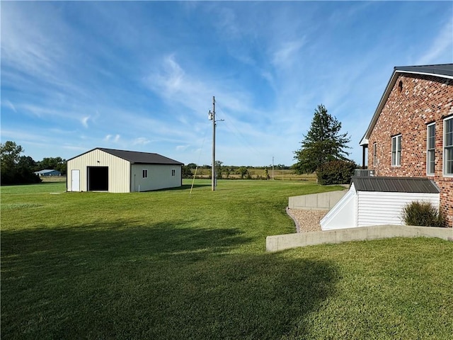 view of yard with cooling unit, an outdoor structure, and a garage