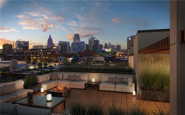 patio terrace at dusk featuring an outdoor living space with a fire pit