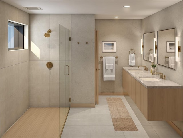 bathroom with a shower with door, vanity, and tile patterned floors