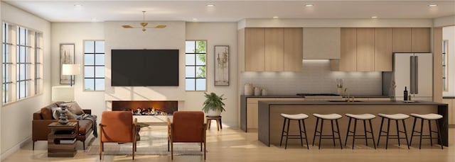 living room with sink and light hardwood / wood-style flooring