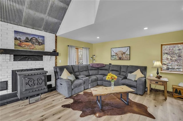 living area featuring vaulted ceiling, wood finished floors, and recessed lighting