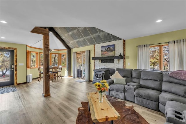 living room featuring baseboards, vaulted ceiling, wood finished floors, and recessed lighting