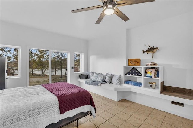 bedroom with light tile patterned floors, access to outside, and a ceiling fan