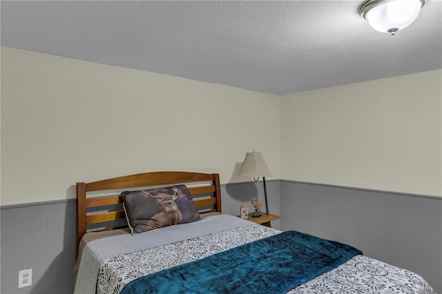 bedroom with a wainscoted wall