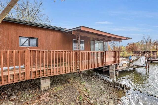 exterior space featuring a dock, a water view, and boat lift