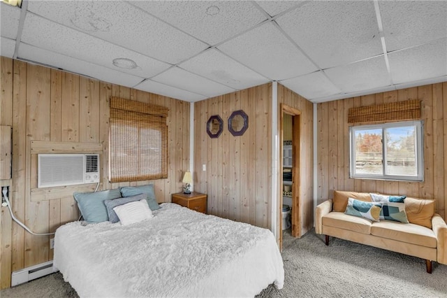 bedroom featuring a baseboard heating unit, carpet, cooling unit, and wood walls