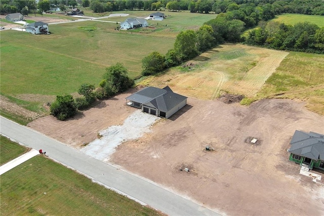 birds eye view of property with a rural view