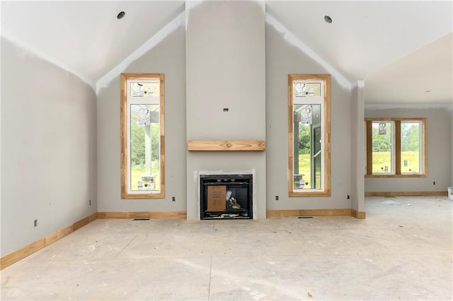 unfurnished living room featuring vaulted ceiling