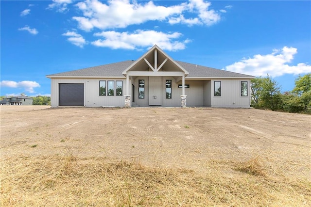 view of front of property with a porch and a garage